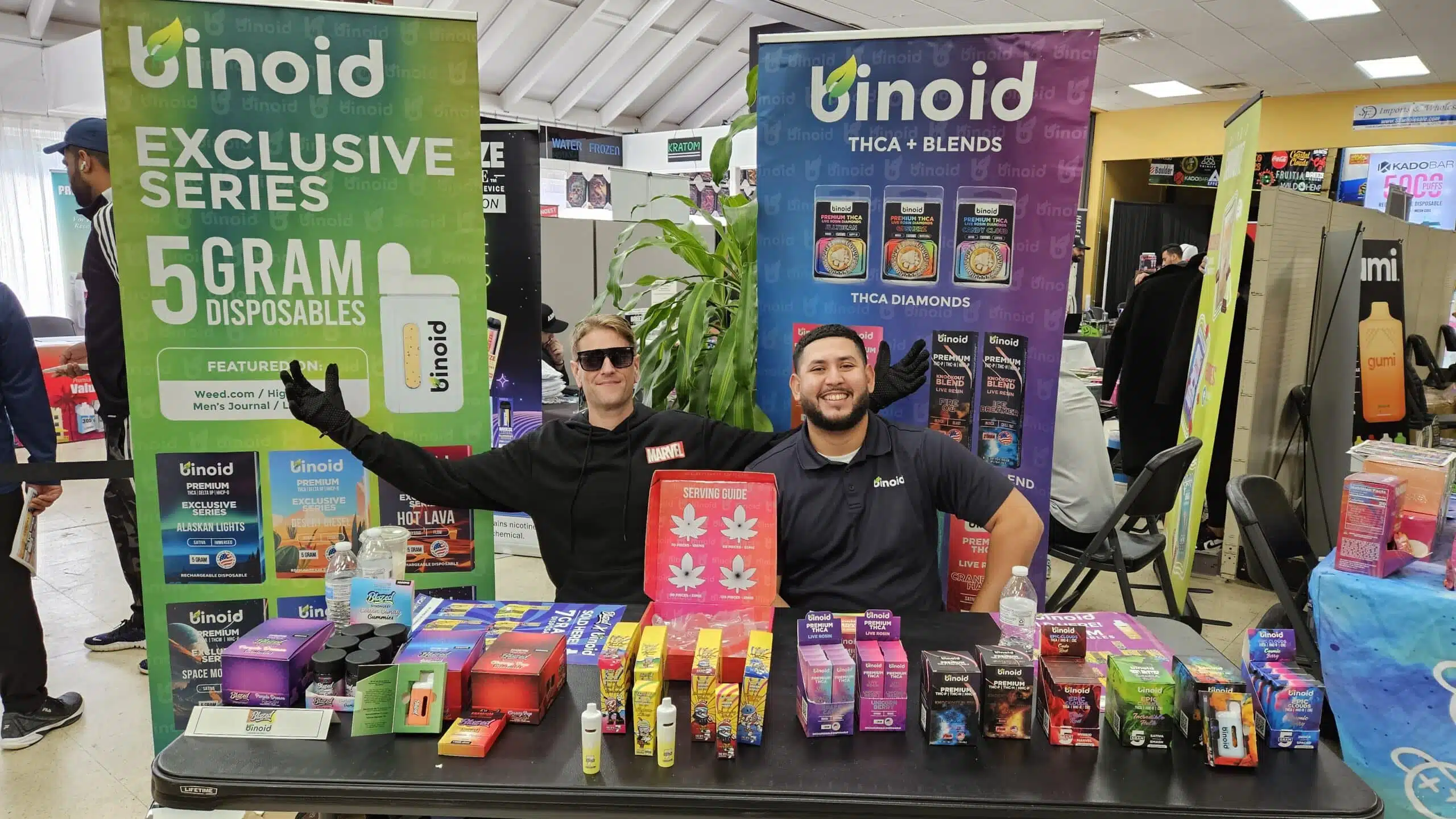 Two brand representatives at their product booth during an SE trade show