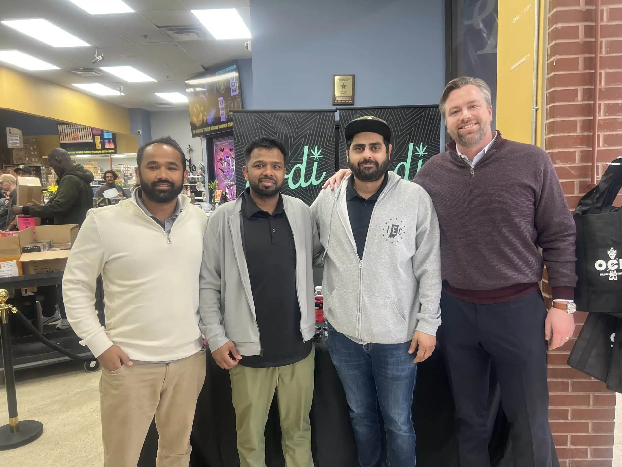 SE team members and a vendor partner at a trade show booth