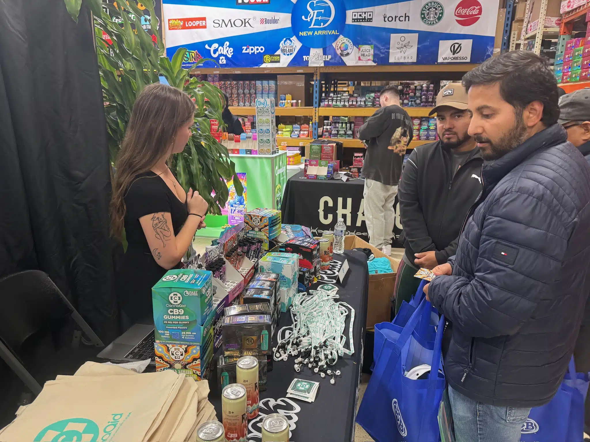 Trade show guests speaking with brand representatives